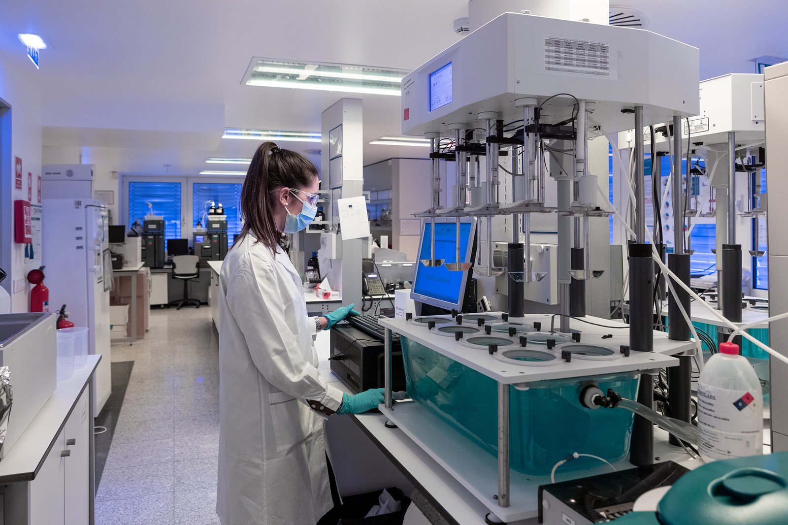 Scientist operating pharmaceutical laboratory equipment